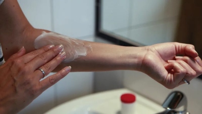 Applying cream on arm