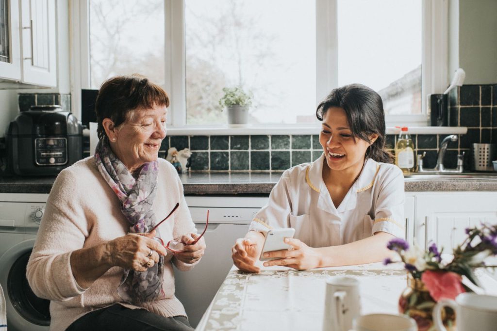 Woman with nurse in kitchen